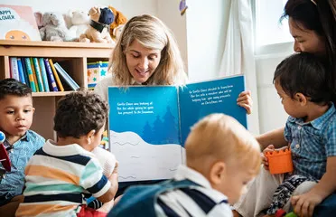 woman reading to circle of kids  