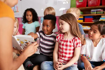 Children sitting in a group and listening to a story
