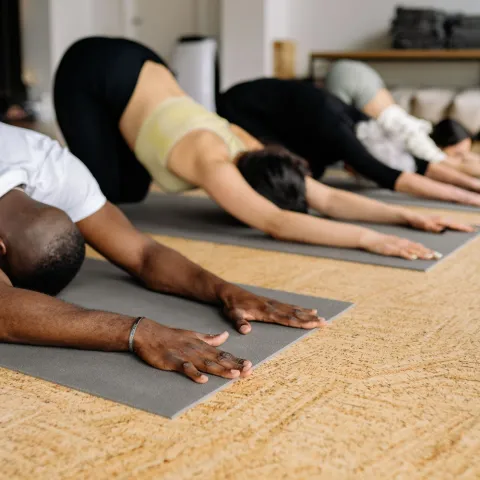 4 people doing a yoga pose