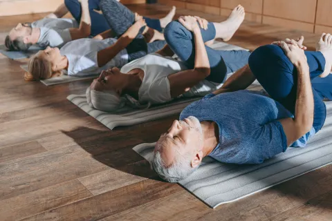 older adults in yoga pose