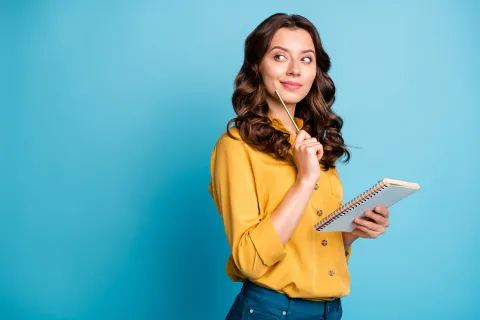 woman holding paper thinking
