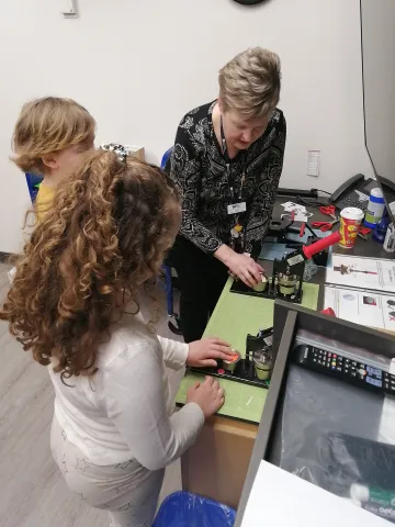 Children using a button maker