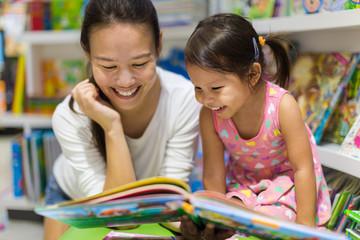 woman reading a book with child