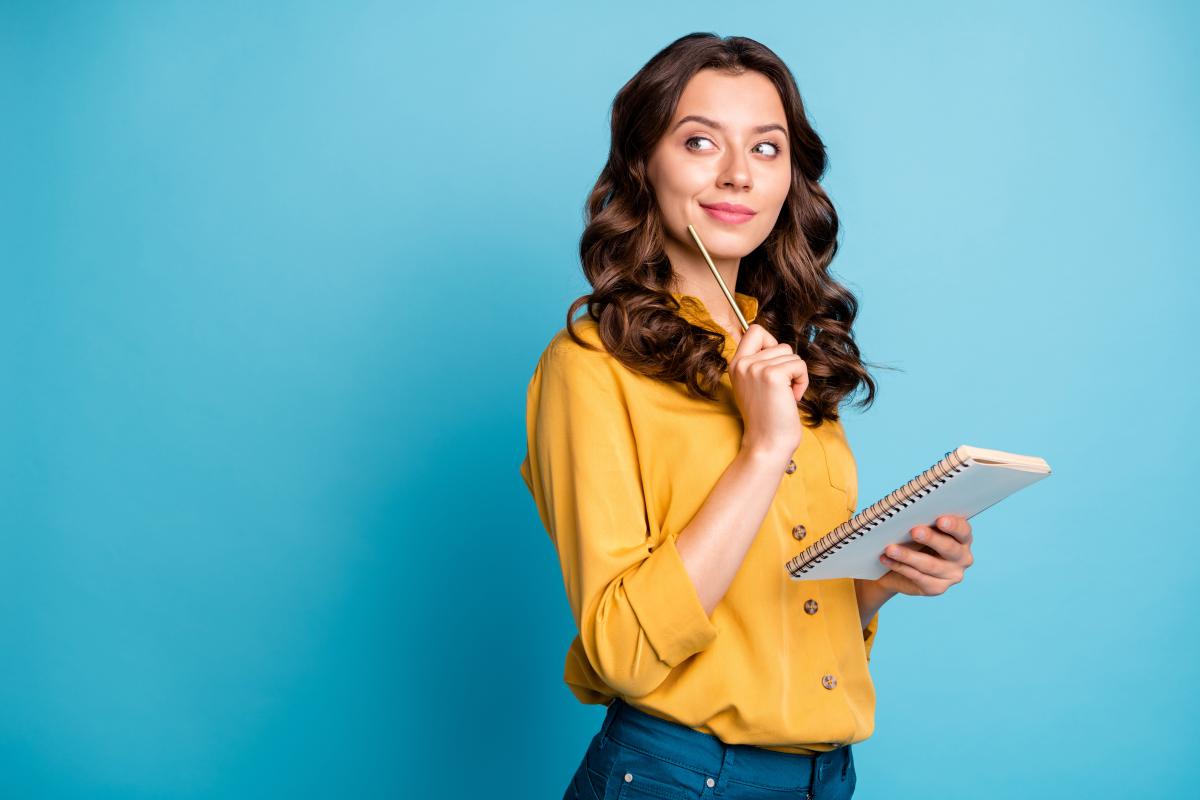 woman holding paper thinking