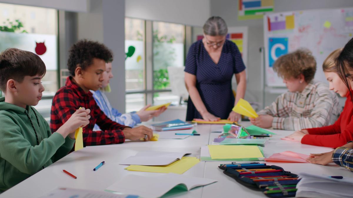 Teens sitting at a table 