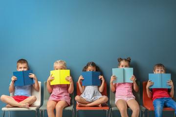 kids with books in front of faces